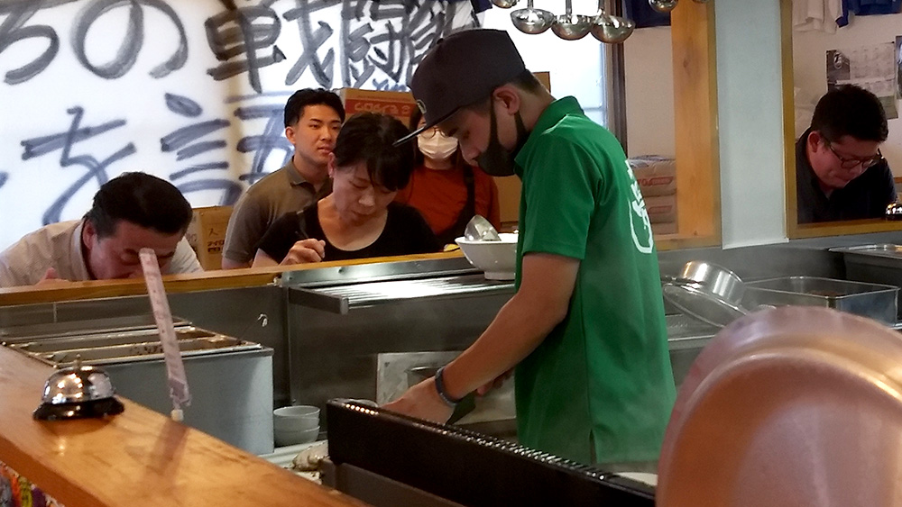 Yume Wo Katara's restaurant manager preparing orders of guests.