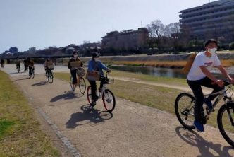 Fridays For Future Kyoto members riding along Kamo River.