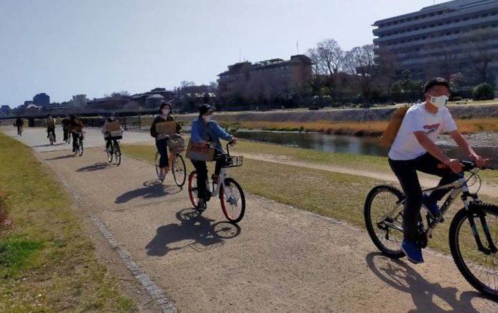 Fridays For Future Kyoto members riding along Kamo River.