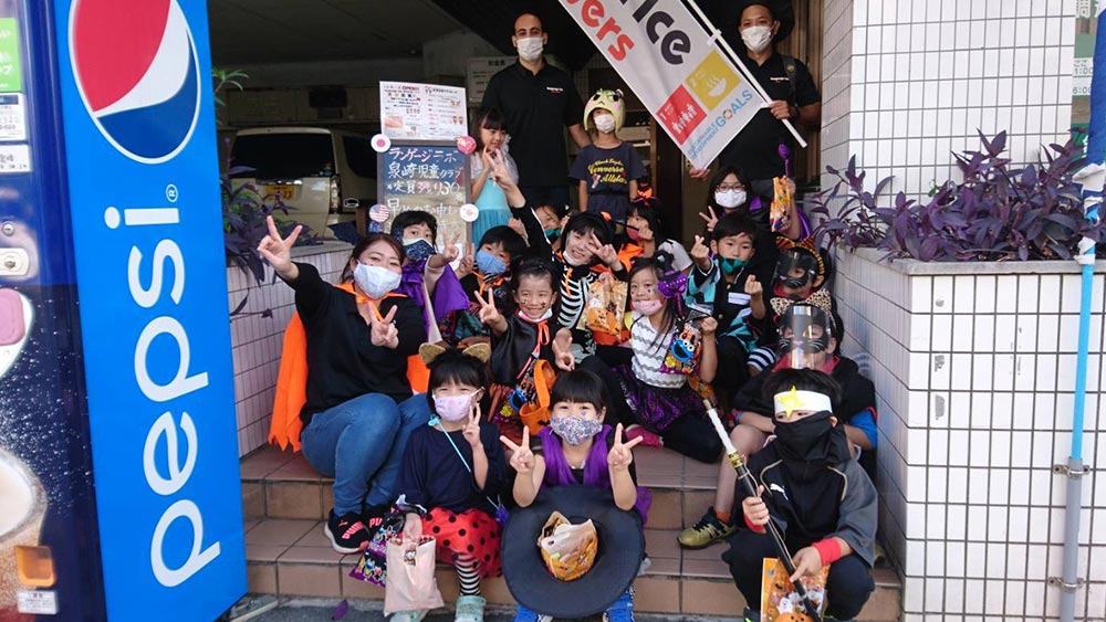 The children of Lab Co. Ltd. posing outside the establishment.