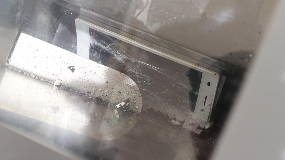 The smartphone being shredded by the ZAURUS smartphone shredder.