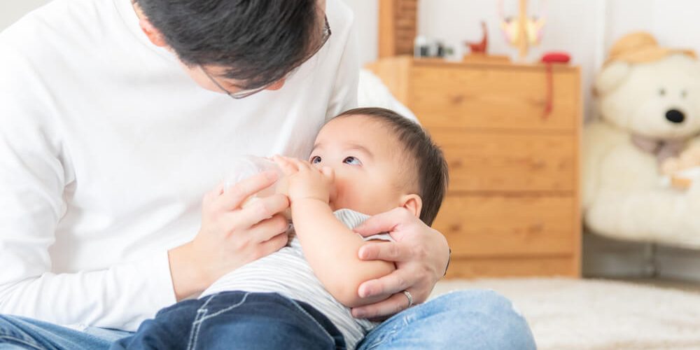 a man taking care of a baby