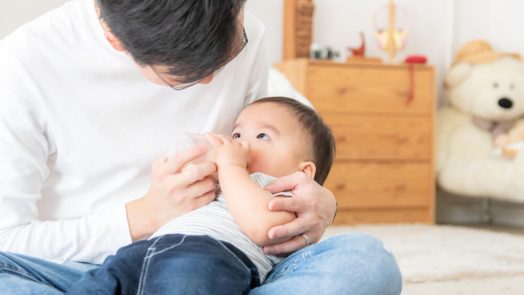 a man taking care of a baby