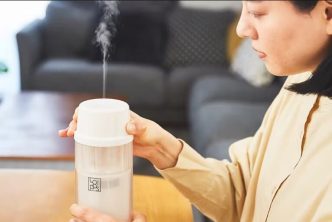 a woman sterilizing baby bottle using “Loipos Bottle Warmer”