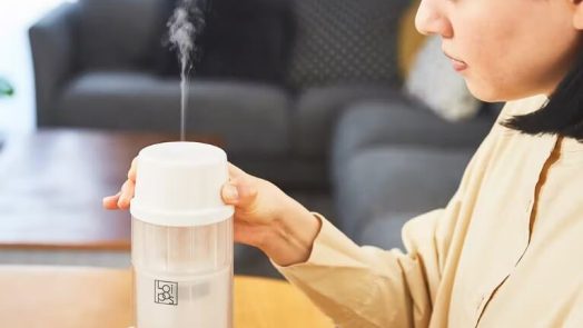 a woman sterilizing baby bottle using “Loipos Bottle Warmer”