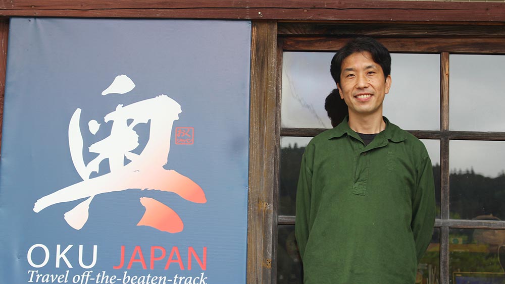 Ryo Uchida, Kumano Operations, standing in front of the Oku Japan KK office.